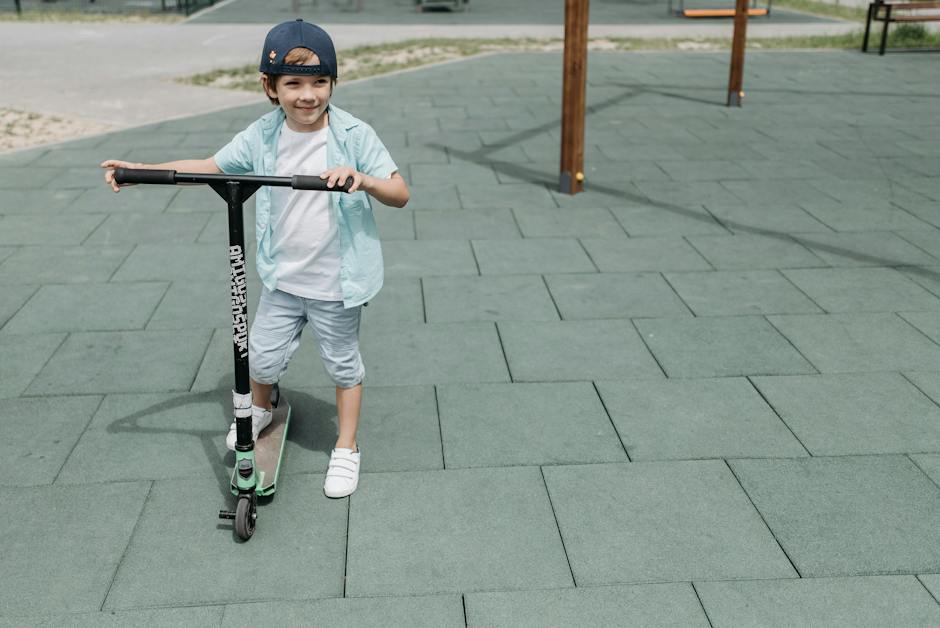 A child riding an e-scooter with a big smile on his face, showcasing the joy and excitement of riding a scooter outdoors while adhering to safety precautions.